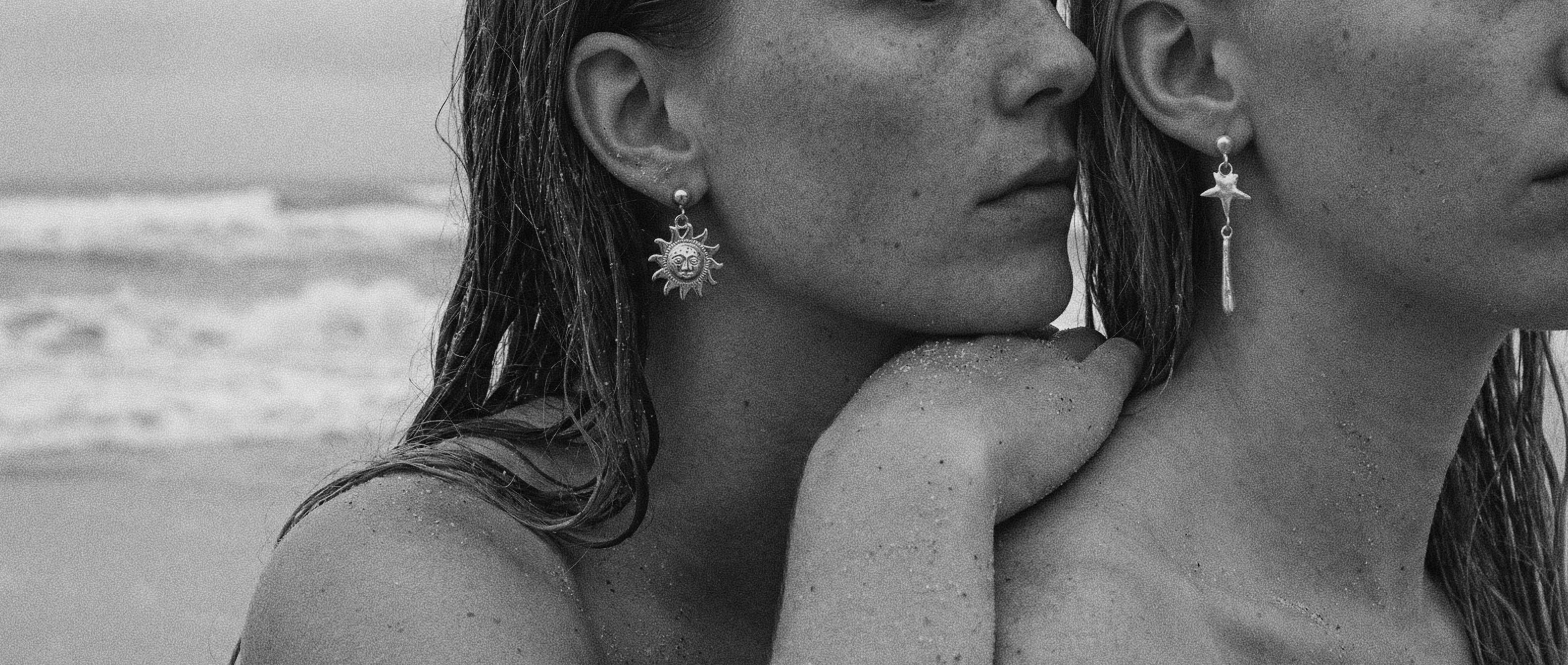 Two women on a beach with ocean waves in the background